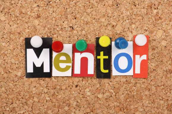 The word Mentor in magazine letters on a notice board